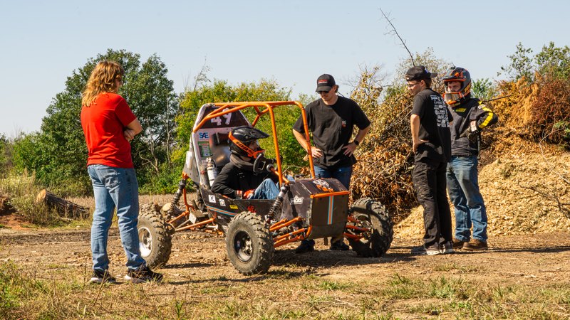 Orange ONU Baja SAE car number 49 testing on a dirt course