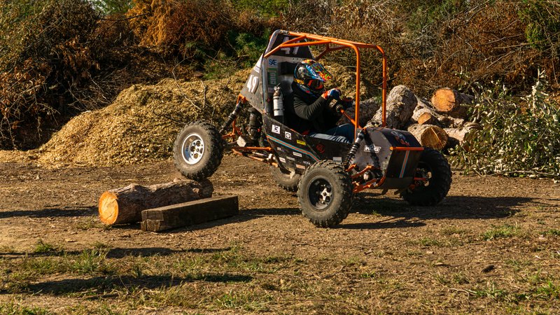 Orange ONU Baja SAE car number 49 testing on a dirt course