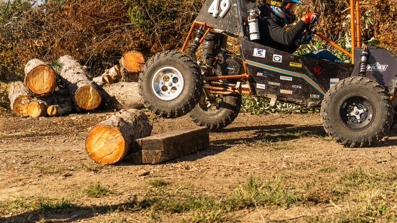 Orange ONU Baja SAE car number 49 testing on a dirt course