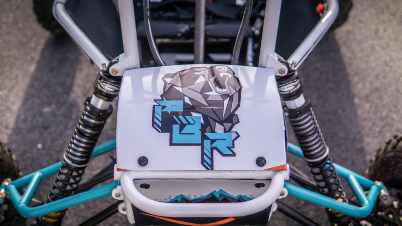 Top-down view of the team logo between the front shocks of Baja car number 32